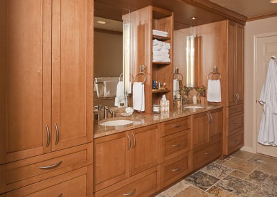 Abbey's built-in cabinety with 2 vanities compliments the rustic stone-look floor