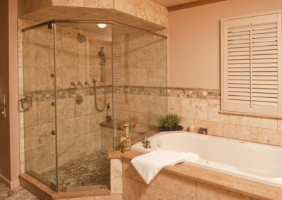Abbey's custom bathroom design, step-in shower in brown stone tile with garden tub