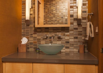 Abbey's bathroom, anigre wood cabinets, quartz countertop, glass bowl sink with wall faucetry
