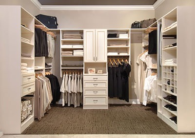 Abbey's can design for you a large walk-in closet, white cabinets, drawers, and shelves