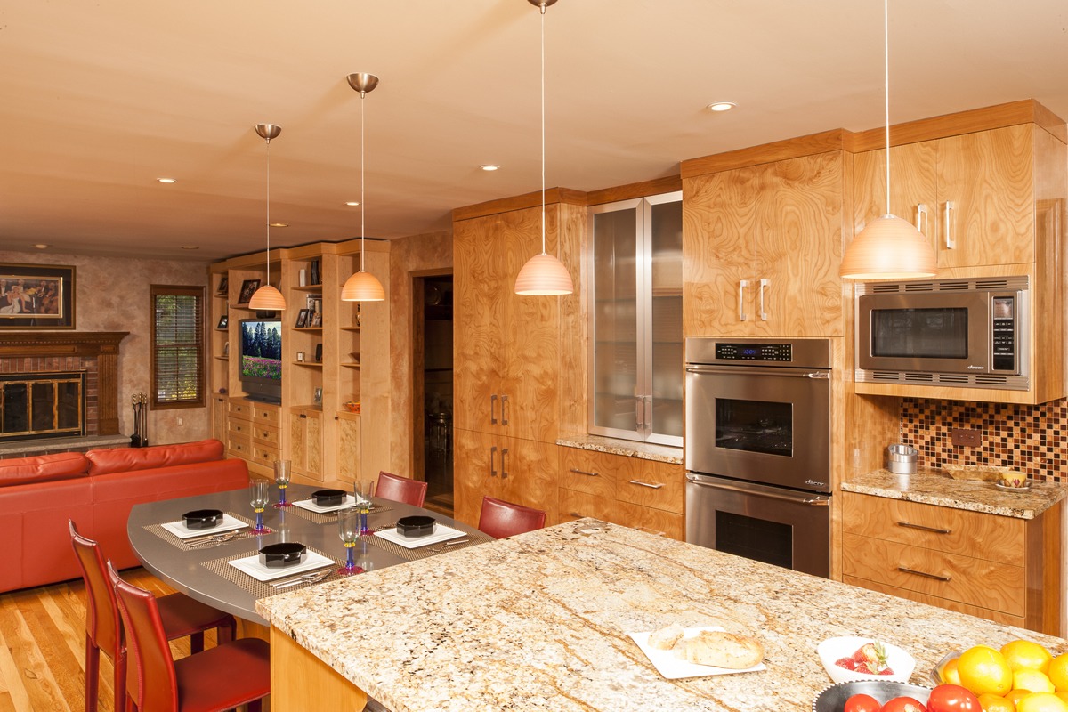 Abbey's custom polished red birch cabinets flow from kitchen and eat-in area to the family room.