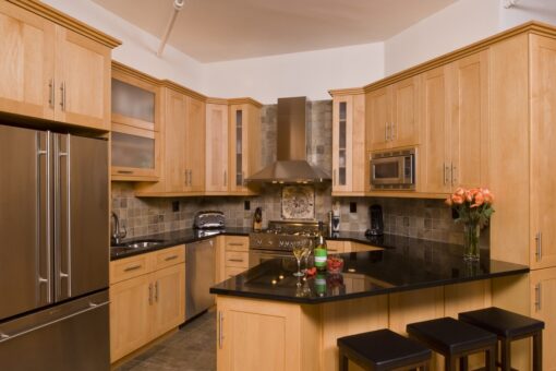 Abbey's custom kitchen design with medium wood cabinets and attached breakfast bar