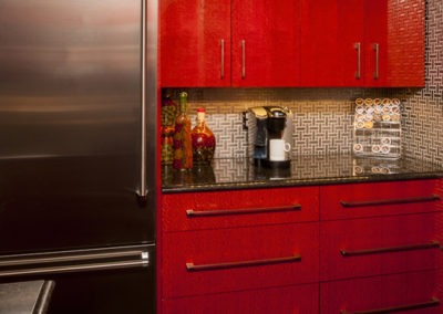 Abbey's modern custom design kitchen with highly polished red cabinets, stainless accents