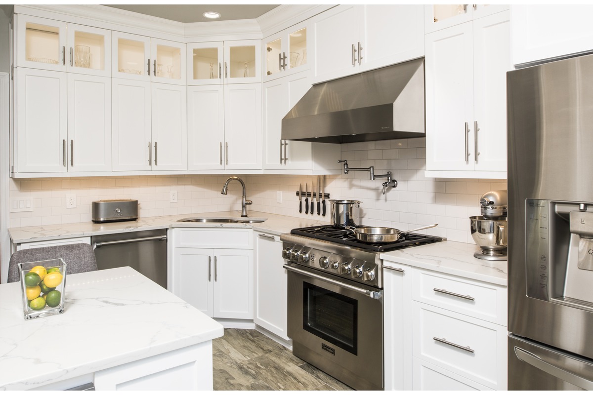 Abbey's custom kitchen with white cabinets and stainless steel accents