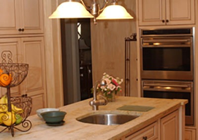 Abbey's custom kitchen design with white washed wood cabinets, stainless appliances