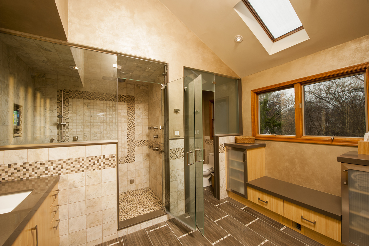 Abbey's custom bathroom design with step-in shower and private toilet with glass doors