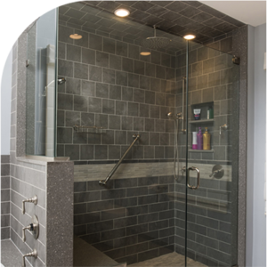 Custom detailed shower stall; glass doors, bench, handrail