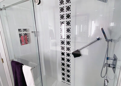 Abbey's clean galley bathroom design with decorative tile